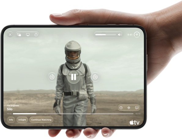 iPhone Duo, held with one hand, opened in horizontal orientation, fully unfolded, interior screen displays Apple TV show “Silo”